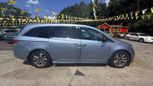 2014 Blue Honda Odyssey Touring | Touring Elite (5FNRL5H99EB) with an 3.5L V-6 i-VTEC variable valve control engine, located at 1806 Veterans Memorial Hwy SW, Austell, GA, 30168, (770) 944-9558, 33.817959, -84.606987 - Photo#2
