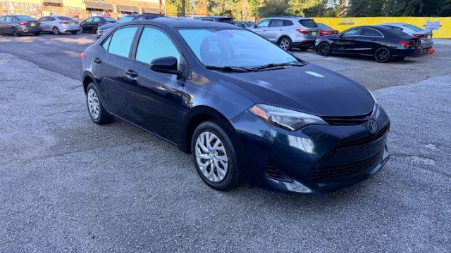 2018 Blue Toyota Corolla LE (5YFBURHE2JP) with an 1.8L I-4 DOHC engine, located at 1806 Veterans Memorial Hwy SW, Austell, GA, 30168, (770) 944-9558, 33.817959, -84.606987 - Photo#3