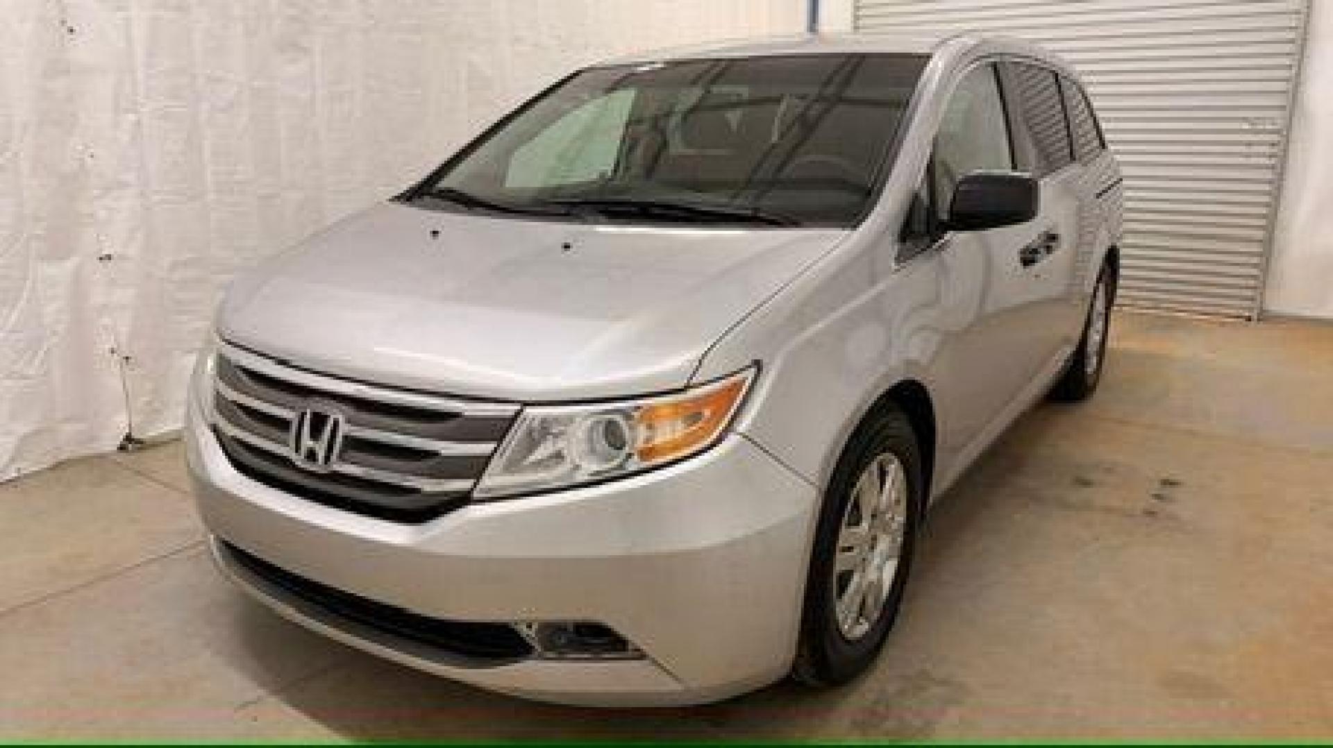 2013 Silver Honda Odyssey LX (5FNRL5H24DB) with an 3.5L V-6 i-VTEC variable valve control engine, located at 1806 Veterans Memorial Hwy SW, Austell, GA, 30168, (770) 944-9558, 33.817959, -84.606987 - Photo#0