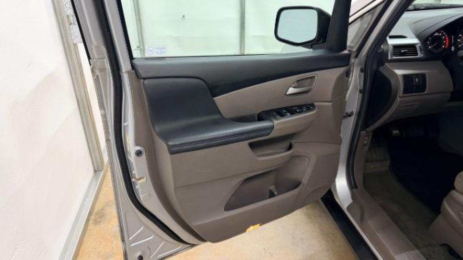 2013 Silver Honda Odyssey LX (5FNRL5H24DB) with an 3.5L V-6 i-VTEC variable valve control engine, located at 1806 Veterans Memorial Hwy SW, Austell, GA, 30168, (770) 944-9558, 33.817959, -84.606987 - Photo#10