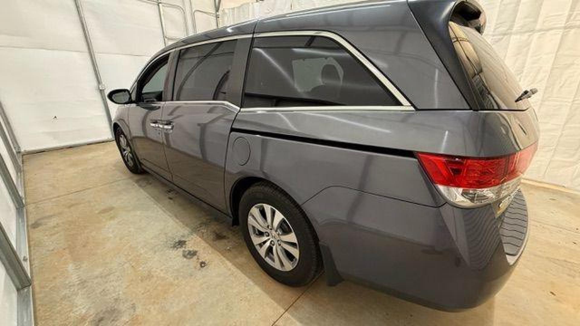 2016 Gray Honda Odyssey SE (5FNRL5H32GB) with an 3.5L V-6 i-VTEC variable valve control engine, located at 1806 Veterans Memorial Hwy SW, Austell, GA, 30168, (770) 944-9558, 33.817959, -84.606987 - Photo#1