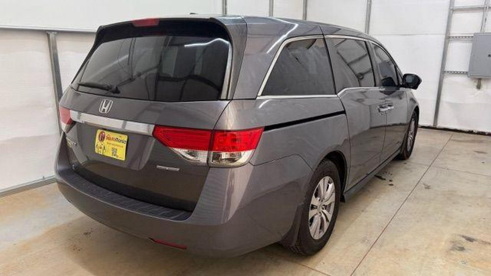2016 Gray Honda Odyssey SE (5FNRL5H32GB) with an 3.5L V-6 i-VTEC variable valve control engine, located at 1806 Veterans Memorial Hwy SW, Austell, GA, 30168, (770) 944-9558, 33.817959, -84.606987 - Photo#4