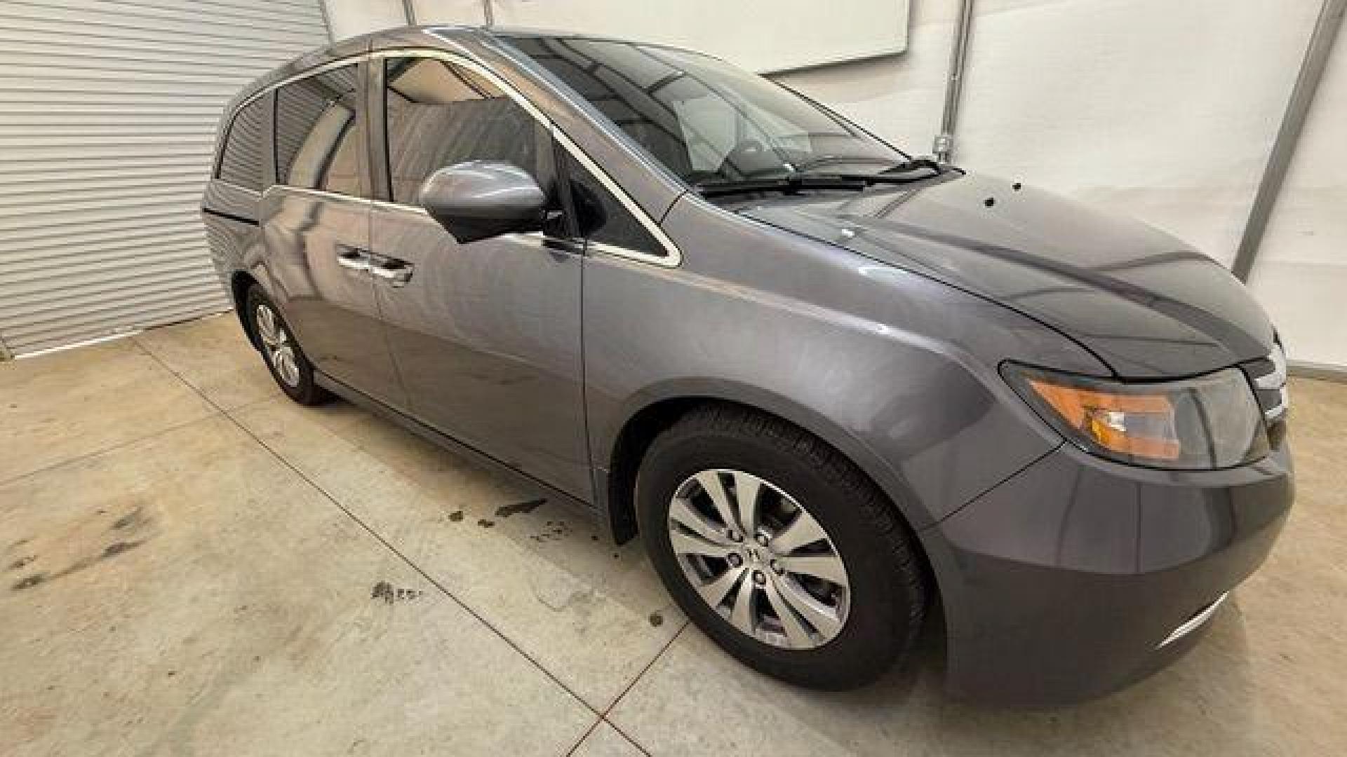 2016 Gray Honda Odyssey SE (5FNRL5H32GB) with an 3.5L V-6 i-VTEC variable valve control engine, located at 1806 Veterans Memorial Hwy SW, Austell, GA, 30168, (770) 944-9558, 33.817959, -84.606987 - Photo#6