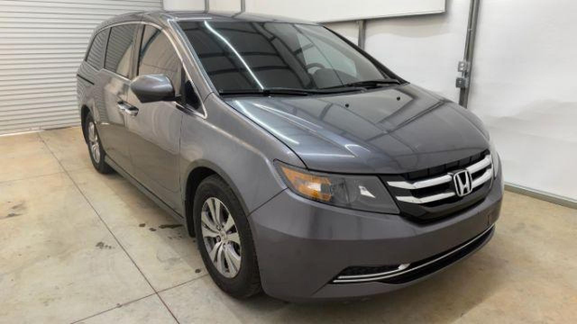 2016 Gray Honda Odyssey SE (5FNRL5H32GB) with an 3.5L V-6 i-VTEC variable valve control engine, located at 1806 Veterans Memorial Hwy SW, Austell, GA, 30168, (770) 944-9558, 33.817959, -84.606987 - Photo#7