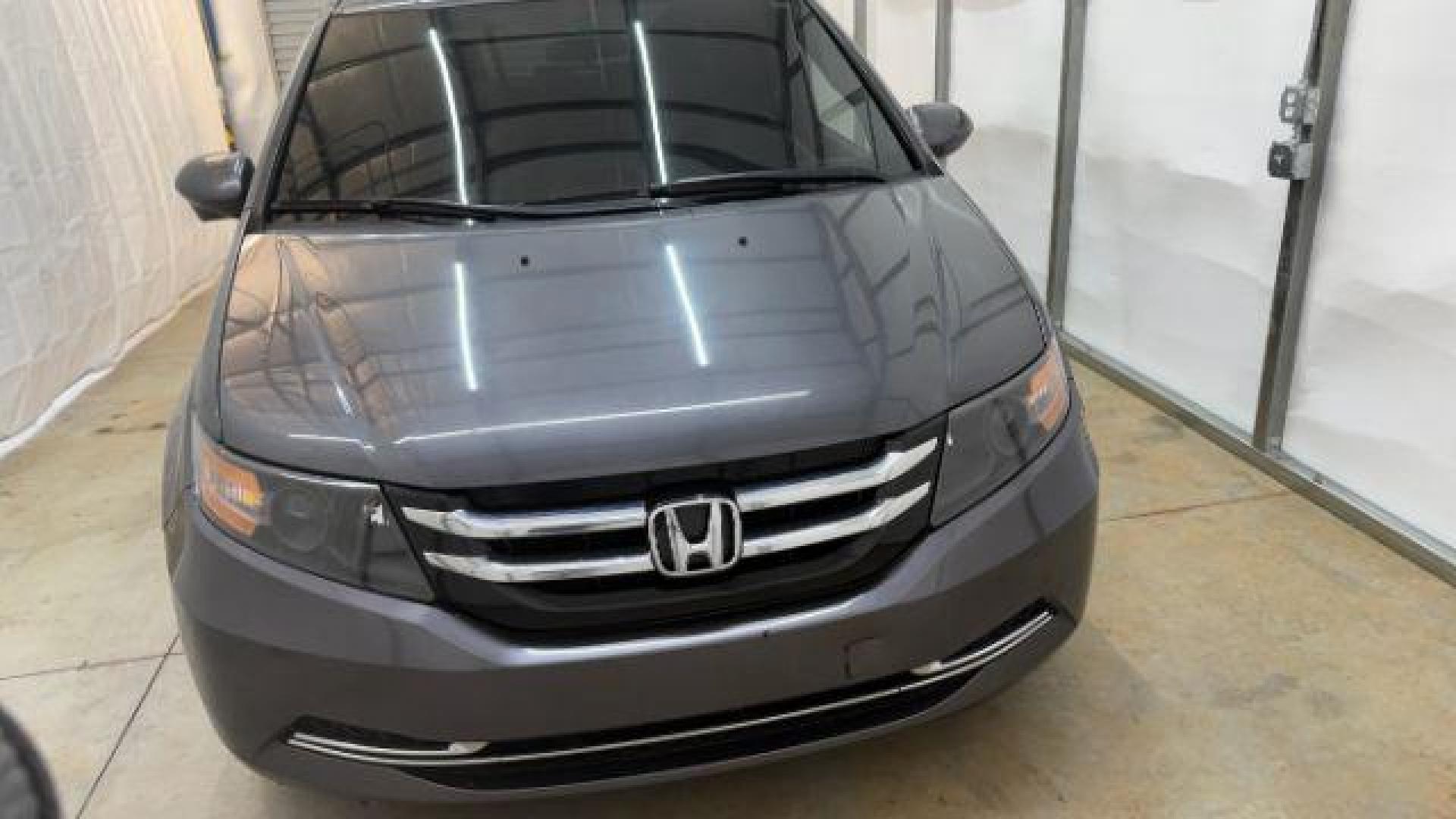 2016 Gray Honda Odyssey SE (5FNRL5H32GB) with an 3.5L V-6 i-VTEC variable valve control engine, located at 1806 Veterans Memorial Hwy SW, Austell, GA, 30168, (770) 944-9558, 33.817959, -84.606987 - Photo#8
