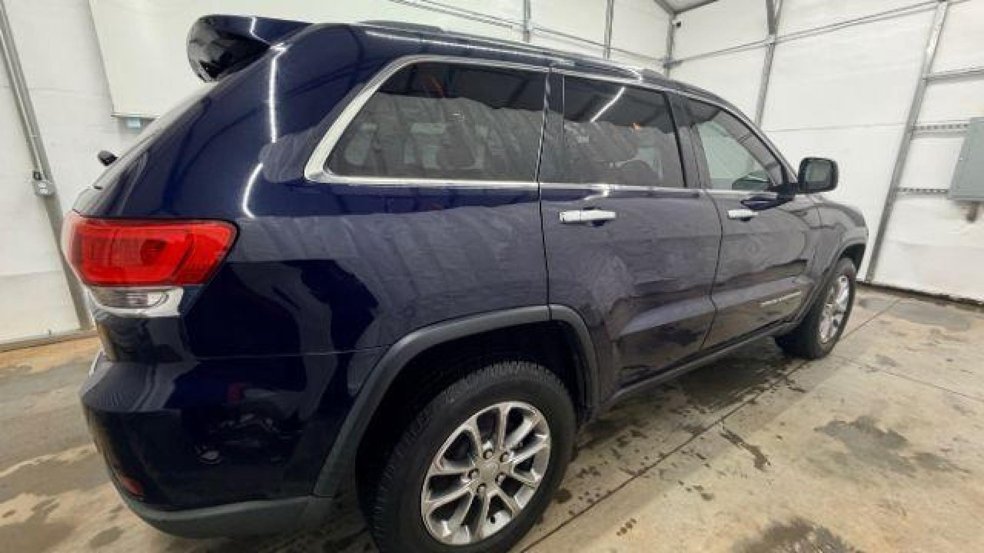 2015 Blue Jeep Grand Cherokee Limited (1C4RJEBG4FC) with an 3.6L V-6 DOHC engine, located at 1806 Veterans Memorial Hwy SW, Austell, GA, 30168, (770) 944-9558, 33.817959, -84.606987 - Photo#6