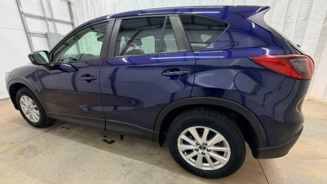 2013 Blue Mazda CX-5 Touring (JM3KE2CE4D0) with an SKYACTIV-G 2L I-4 gasoline direct injection engine, located at 1806 Veterans Memorial Hwy SW, Austell, GA, 30168, (770) 944-9558, 33.817959, -84.606987 - Photo#3