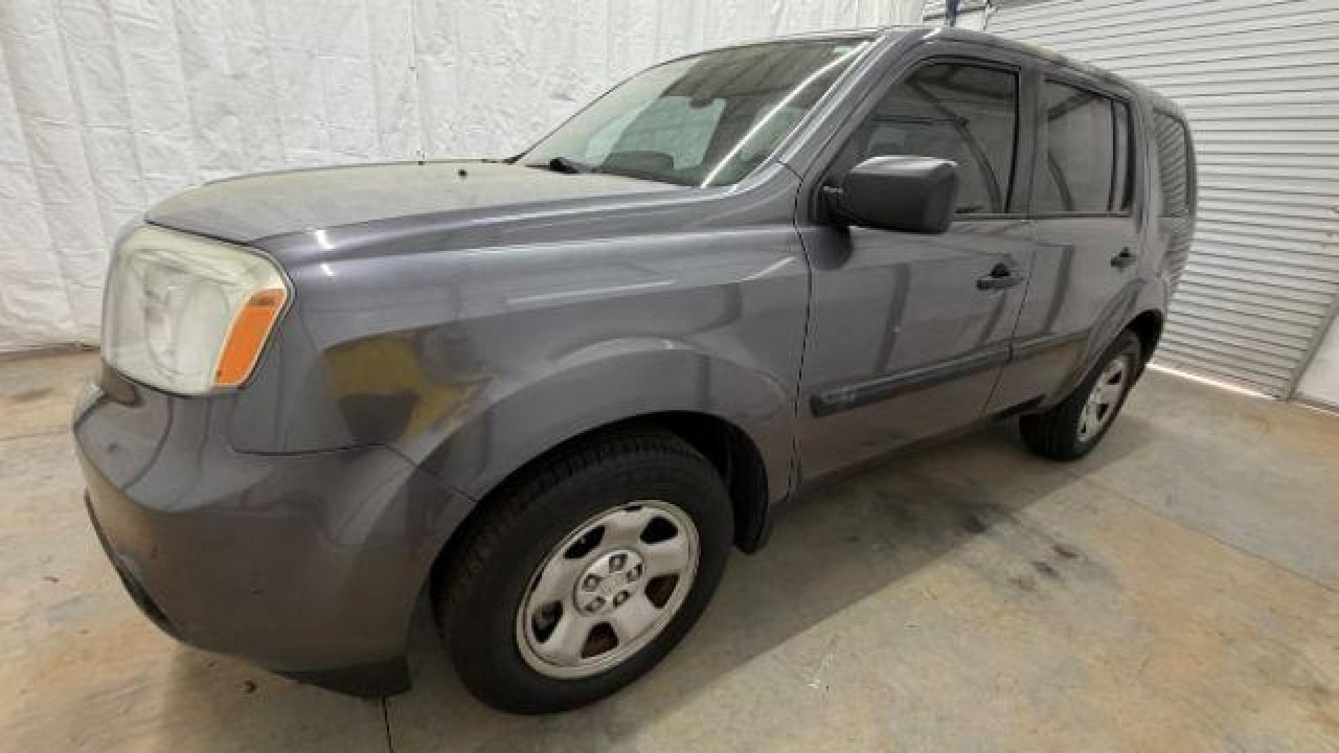2015 Gray Honda Pilot LX (5FNYF3H28FB) with an 3.5L V-6 i-VTEC VCM variable valve control engine, located at 1806 Veterans Memorial Hwy SW, Austell, GA, 30168, (770) 944-9558, 33.817959, -84.606987- Photo#1