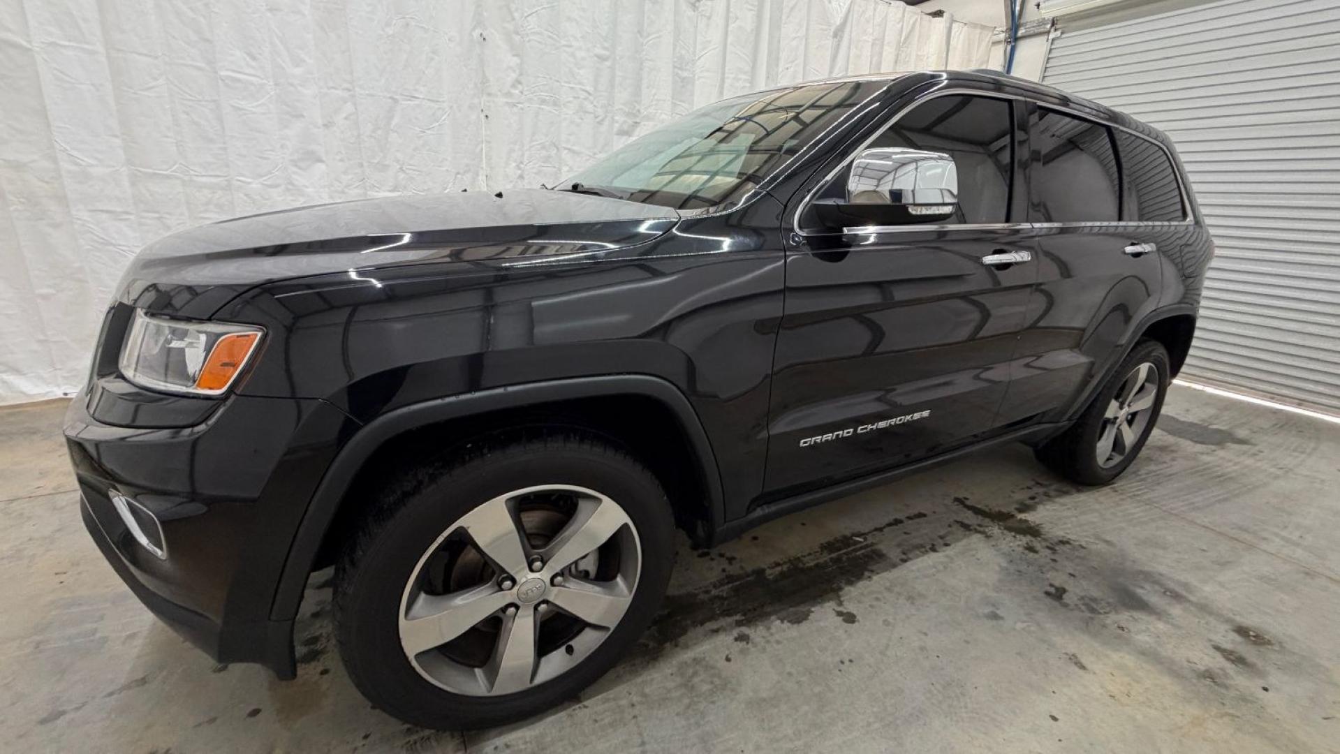 2015 Black Jeep Grand Cherokee Limited (1C4RJEBGXFC) , located at 1806 Veterans Memorial Hwy SW, Austell, GA, 30168, (770) 944-9558, 33.817959, -84.606987- Photo#1