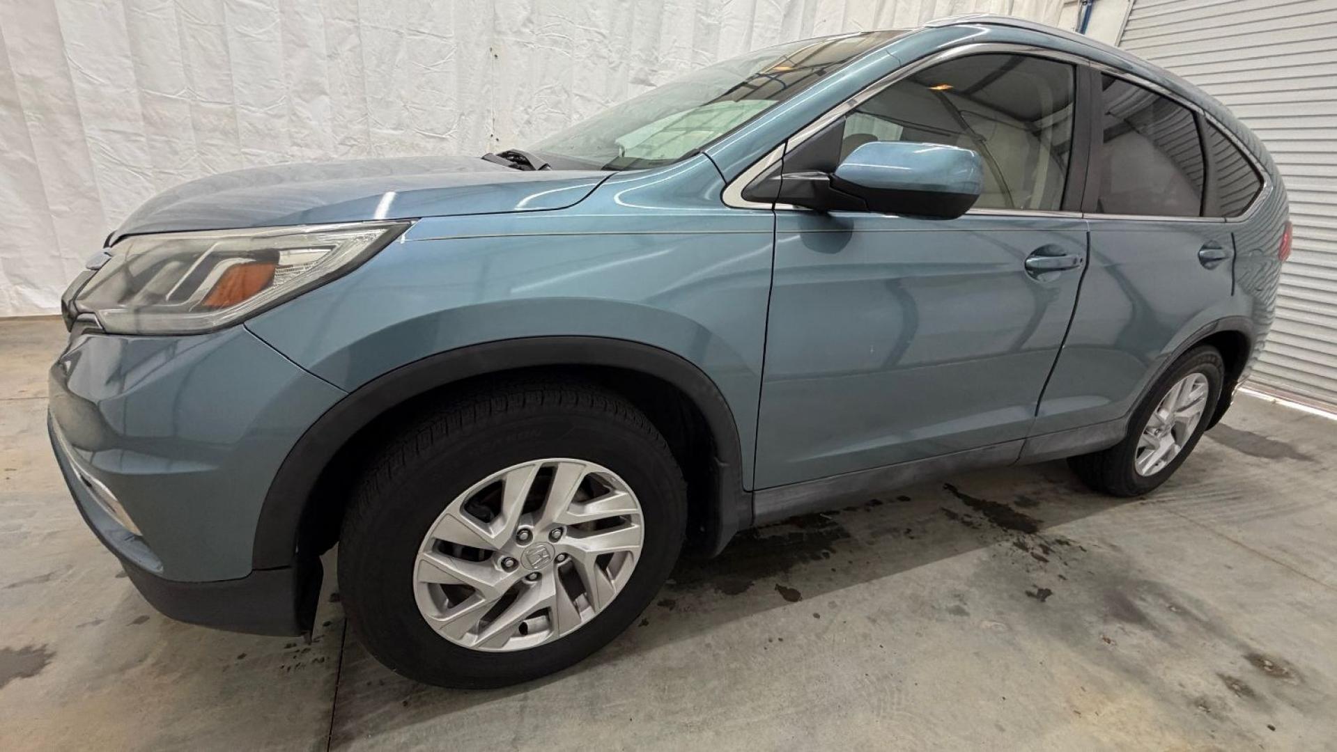 2015 Teal Honda CR-V EX-L (2HKRM3H79FH) with an 2.4L I-4 gasoline direct injection engine, located at 1806 Veterans Memorial Hwy SW, Austell, GA, 30168, (770) 944-9558, 33.817959, -84.606987- Photo#1