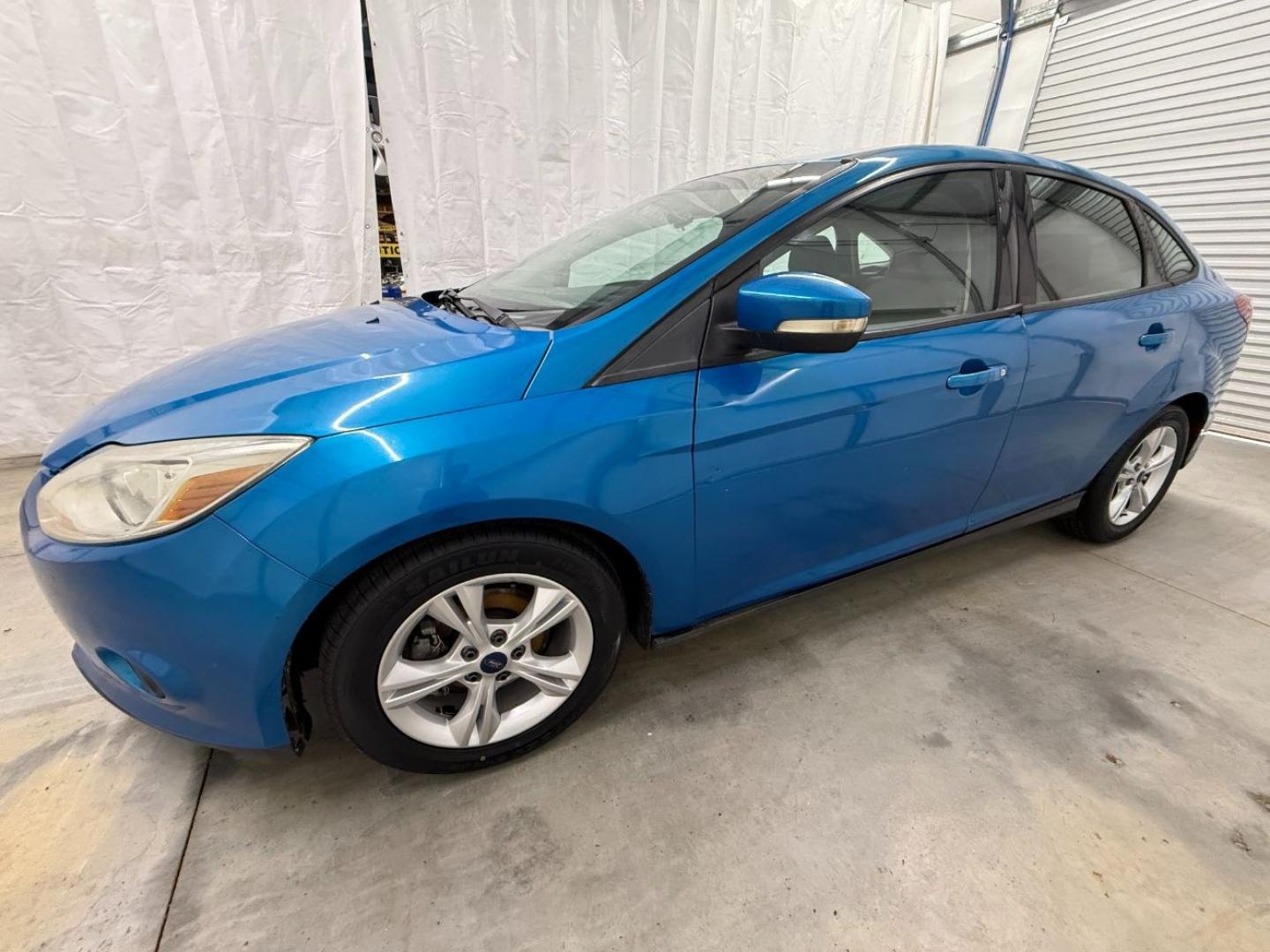 2014 Blue Ford Focus SE (1FADP3F20EL) with an 2L I-4 gasoline direct injection engine, located at 1806 Veterans Memorial Hwy SW, Austell, GA, 30168, (770) 944-9558, 33.817959, -84.606987- Photo#1