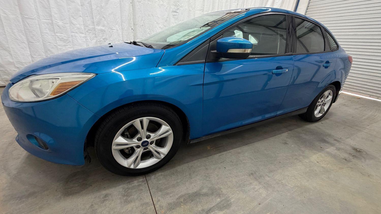 2014 Blue Ford Focus SE (1FADP3F20EL) with an 2L I-4 gasoline dire engine, located at 1806 Veterans Memorial Hwy SW, Austell, GA, 30168, (770) 944-9558, 33.817959, -84.606987- Photo#1