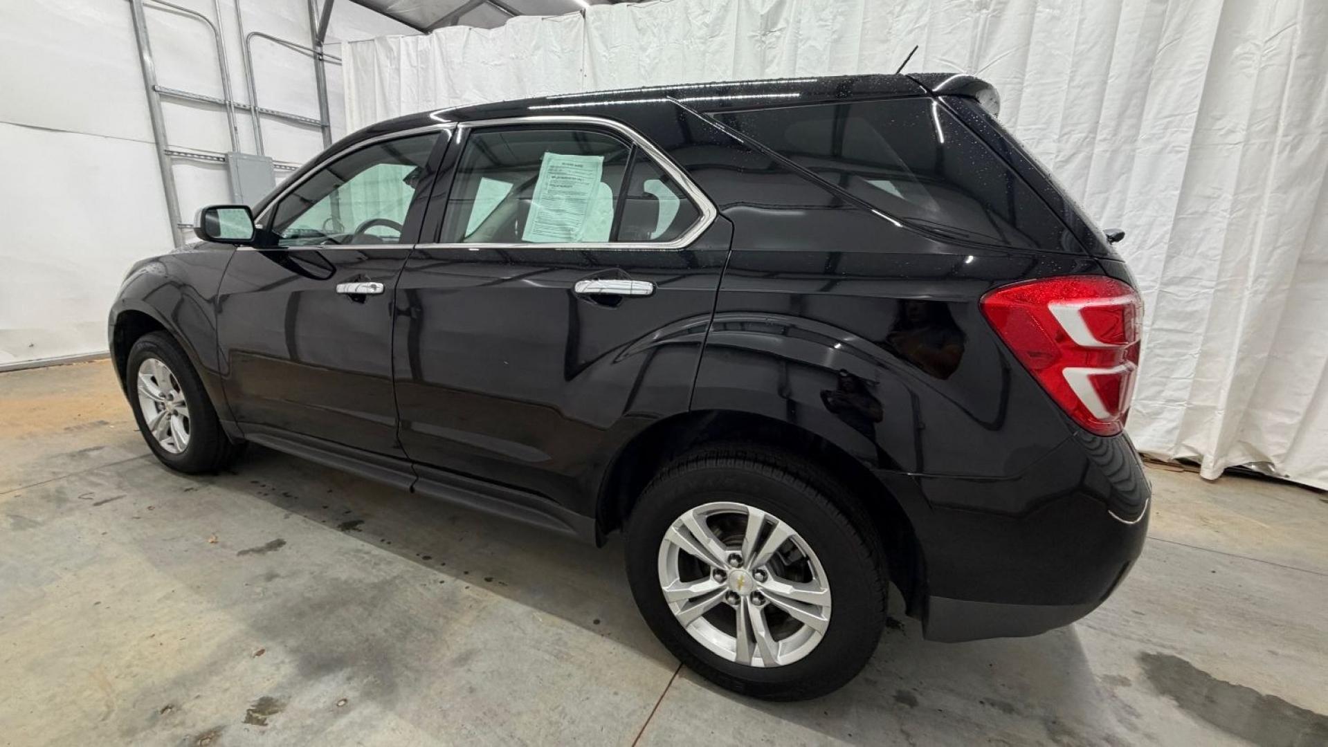 2016 Black Chevrolet Equinox LS (2GNALBEKXG1) with an ECOTEC 2.4L I-4 gasoline direct injection engine, located at 1806 Veterans Memorial Hwy SW, Austell, GA, 30168, (770) 944-9558, 33.817959, -84.606987- Photo#2