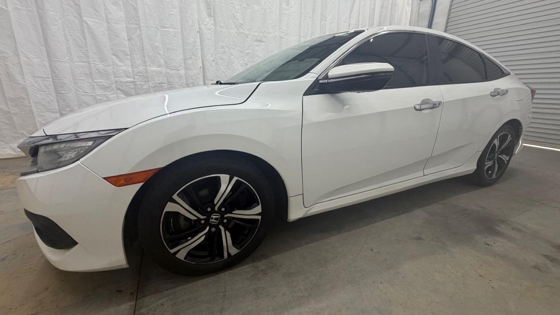 2016 White Honda Civic Touring (2HGFC1F93GH) with an 1.5L I-4 gasoline direct injection engine, located at 1806 Veterans Memorial Hwy SW, Austell, GA, 30168, (770) 944-9558, 33.817959, -84.606987- Photo#2