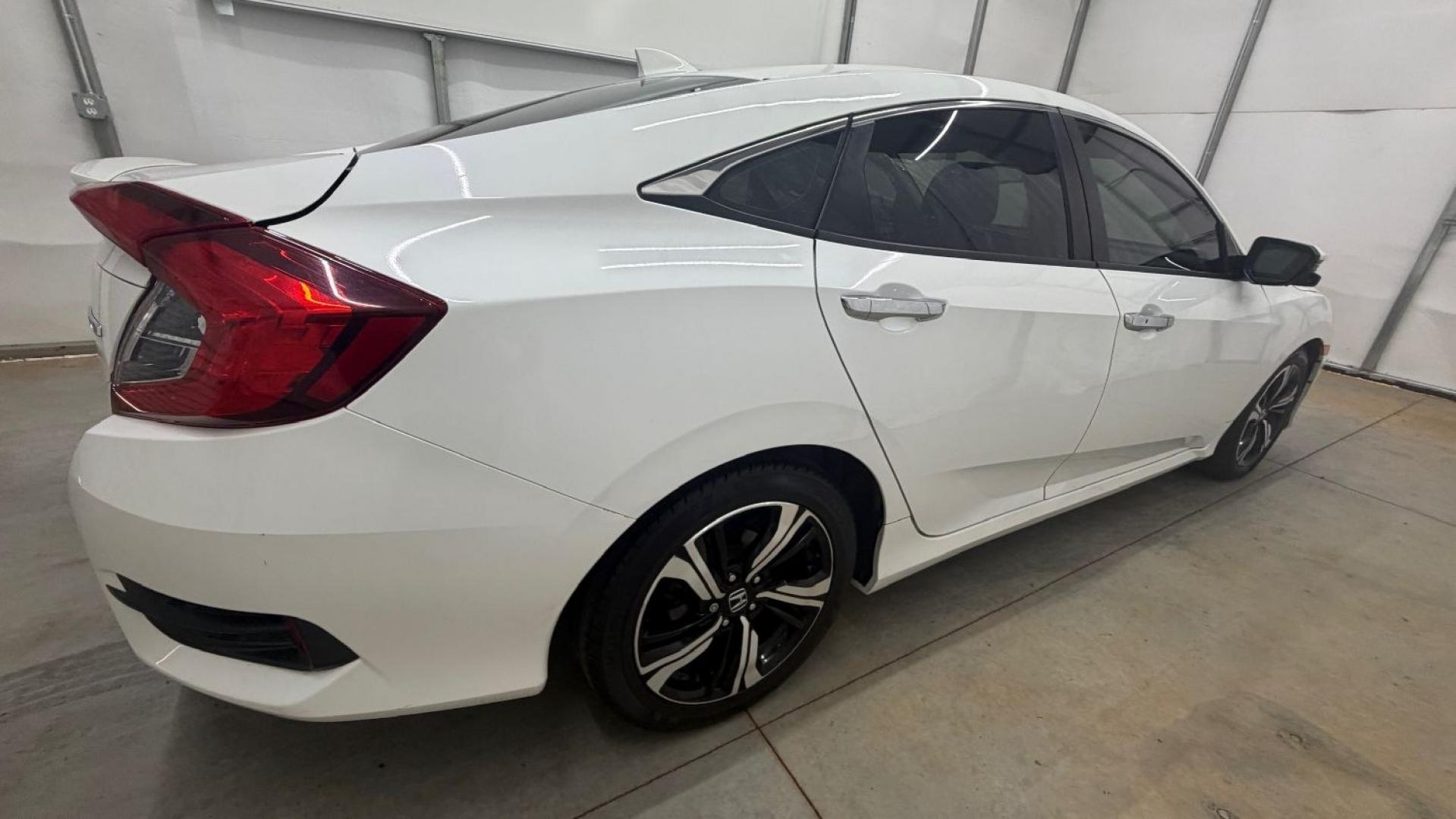 2016 White Honda Civic Touring (2HGFC1F93GH) with an 1.5L I-4 gasoline direct injection engine, located at 1806 Veterans Memorial Hwy SW, Austell, GA, 30168, (770) 944-9558, 33.817959, -84.606987- Photo#7