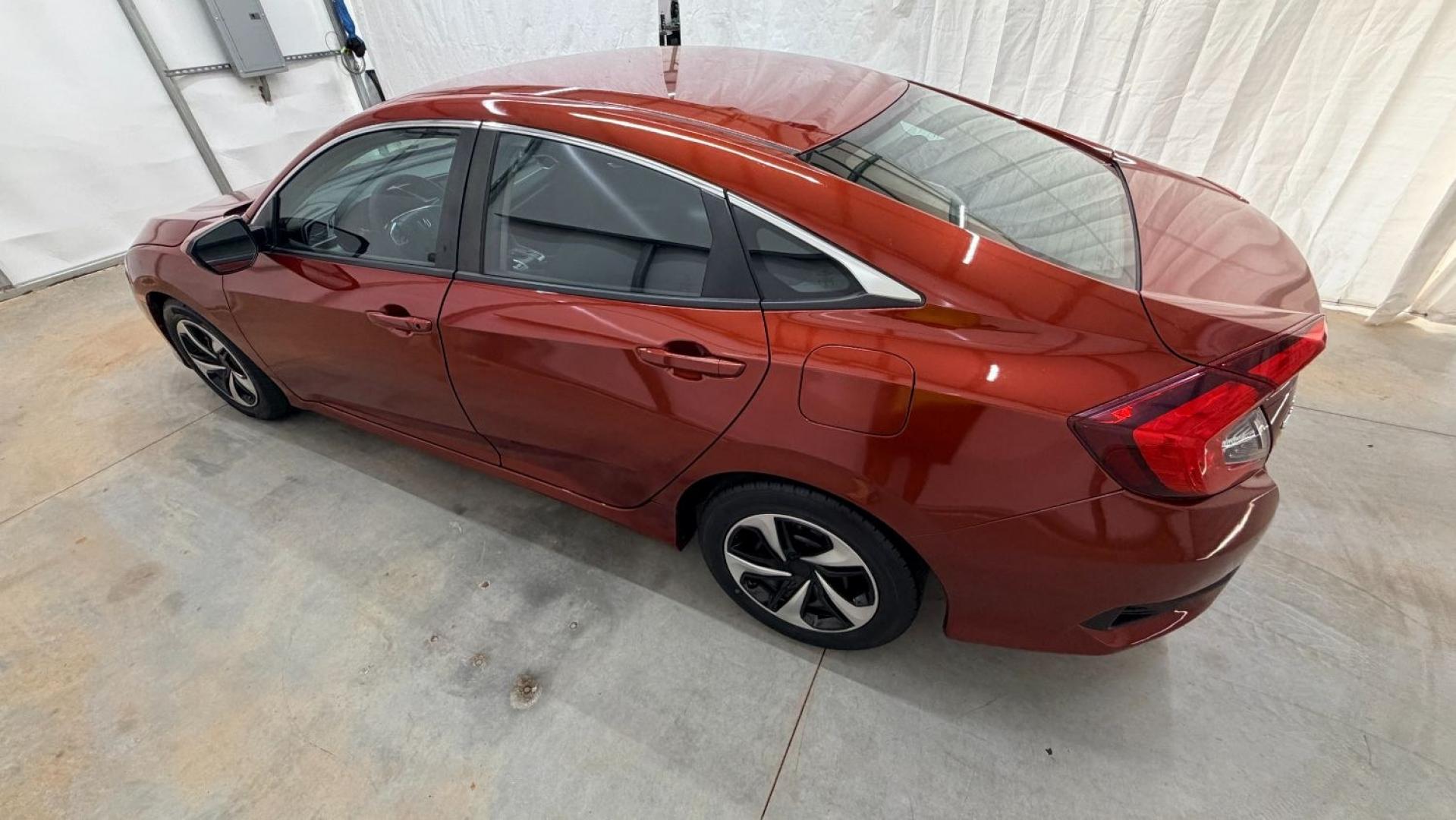 2021 Red Honda Civic Sedan LX (2HGFC2F64MH) with an 2L I-4 DOHC engine, located at 1806 Veterans Memorial Hwy SW, Austell, GA, 30168, (770) 944-9558, 33.817959, -84.606987 - This Honda is in great condition, with paint that looks good and tires that look clean and brand new. Inside, the interior looks impeccable. A reliable, fuel-efficient compact that's ready for daily driving.- Photo#2