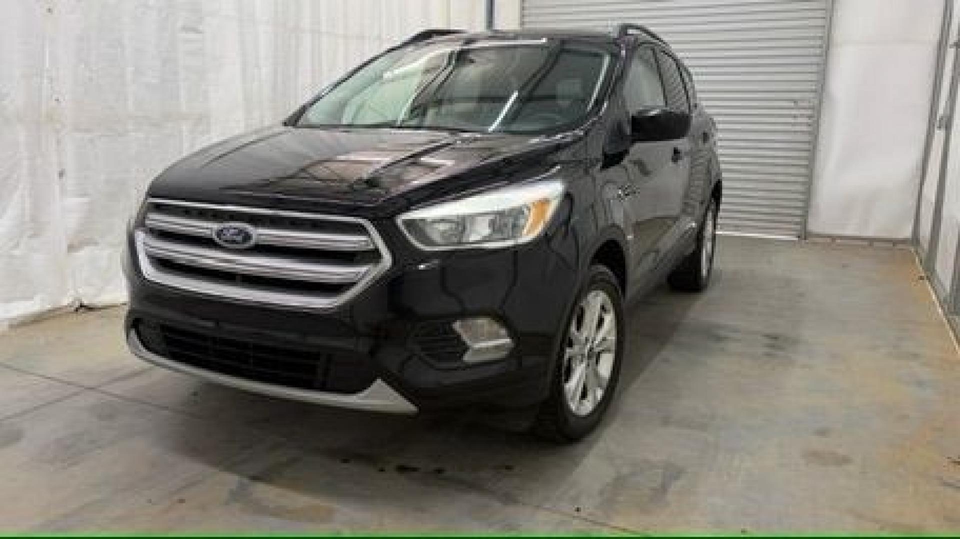 2018 Black Ford Escape SE (1FMCU9GD2JU) with an EcoBoost 1.5L I-4 direct injection engine, located at 1806 Veterans Memorial Hwy SW, Austell, GA, 30168, (770) 944-9558, 33.817959, -84.606987- Photo#0