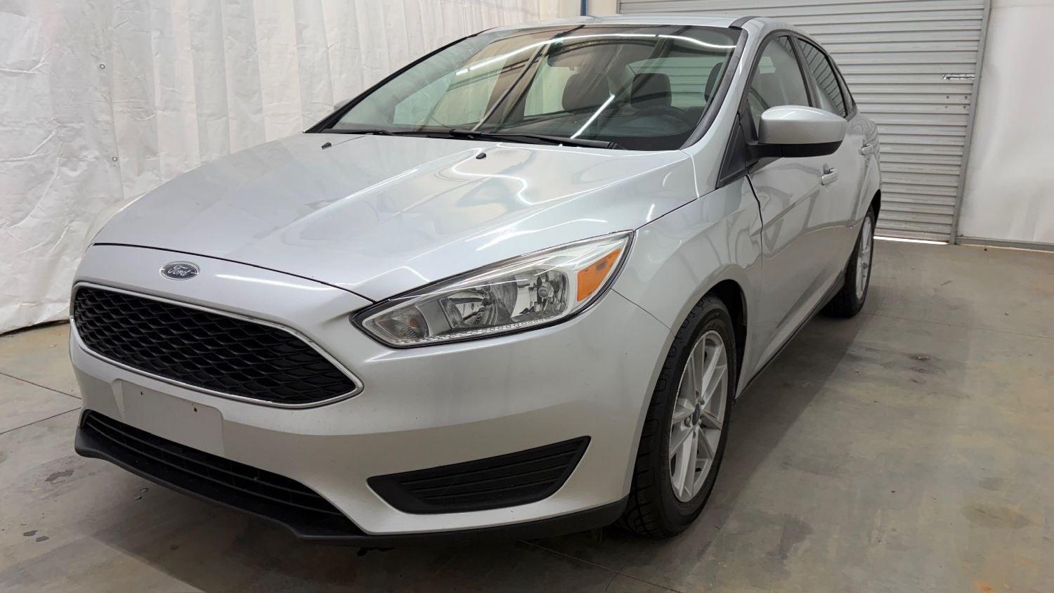 2018 Silver Ford Focus SE (1FADP3F23JL) , located at 1806 Veterans Memorial Hwy SW, Austell, GA, 30168, (770) 944-9558, 33.817959, -84.606987 - This Ford Focus SE has passed a 100+ point inspection performed in our own service center. It's very clean, with no issues to describe and no odors, and the tires are in great condition. Come see it in person and take it for a test drive! Why Choose Automania? At Automania, we make car buying easy- Photo#0