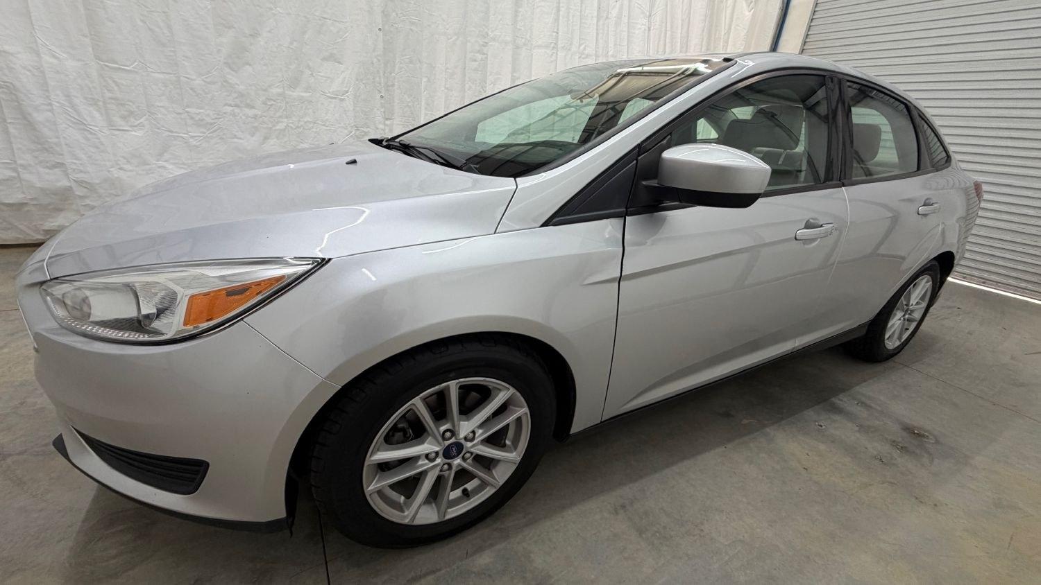 2018 Silver Ford Focus SE (1FADP3F23JL) , located at 1806 Veterans Memorial Hwy SW, Austell, GA, 30168, (770) 944-9558, 33.817959, -84.606987 - This Ford Focus SE has passed a 100+ point inspection performed in our own service center. It's very clean, with no issues to describe and no odors, and the tires are in great condition. Come see it in person and take it for a test drive! Why Choose Automania? At Automania, we make car buying easy- Photo#1